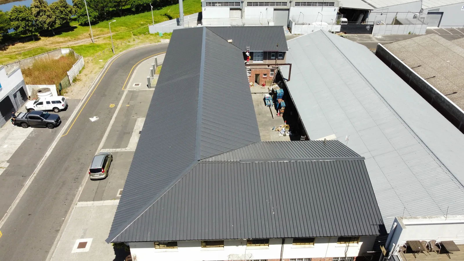 Completed dark metal roof covering viewed from above