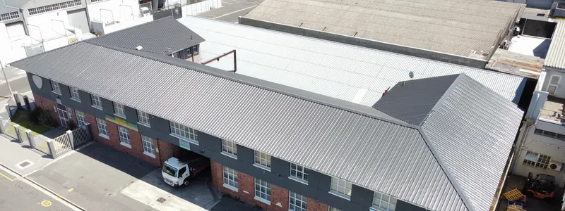 Completed dark roof sheeting and ridge lines viewed obliquely from above