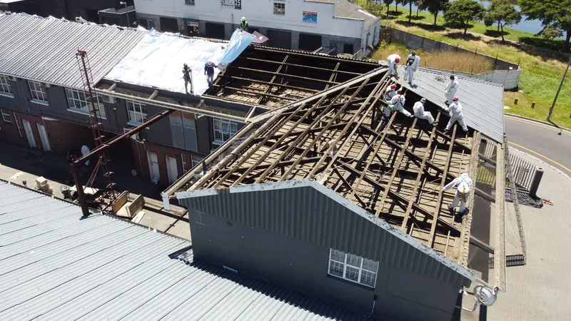 Exposed framing at the gable end with remaining covering and underlay behind